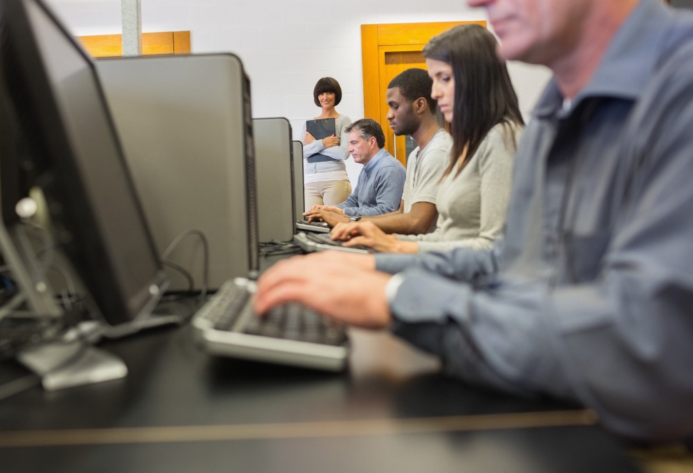 Two people talking at office table with coffee cups, man and woman in business casual